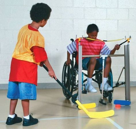 This game of hockey is adapted so the kid in the wheelchair has a chance to play by having a shortened hockey stick attached to her wheelchair. This allows the kid to play even though they are in a seated position. Physical Education Bulletin Boards, Floor Hockey, Adapted Pe, Adapted Physical Education, Education Posters, Education Wallpaper, Elementary Physical Education, Physical Education Lessons, Education Preschool