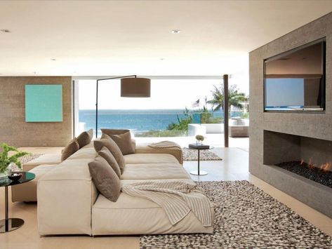 Large plush sofas make room for lounging next to the TV and sleek stone fireplace, or looking out over the incredible ocean views. Contemporary Great Room, Trendy Rugs, California Beach House, Contemporary Beach House, Beach House Living Room, Living Room Decor Inspiration, Ocean House, Beach House Style, Modern Beach House