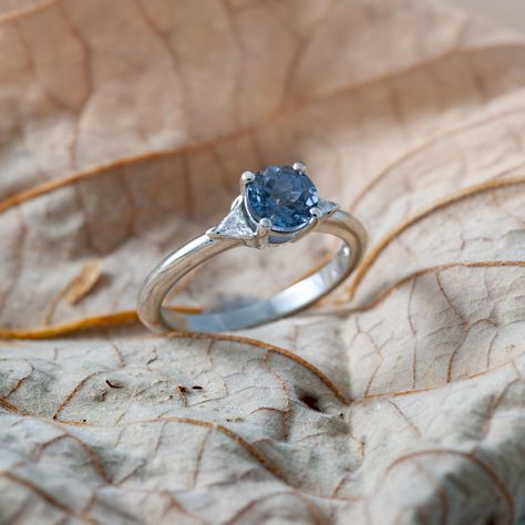 Our Emery engagement ring is handcrafted with 14kt white gold and features a stunning grey-blue spinel, framed with two triangle diamonds💙 #eradesignjewellery #uniqueengagementring #womenownedbusiness #womanowned #ringinspiration #engagementringideas #engagementringinspiration #weddingjewellery #vancouverbridal #shoplocalbc Saphire Engament Ring Set Silver, Saphire Engament Ring Set, Engament Rings, Ring Set Silver, Triangle Diamond, Engagement Ring Inspiration, Blue Spinel, Unique Engagement Rings, Grey Blue