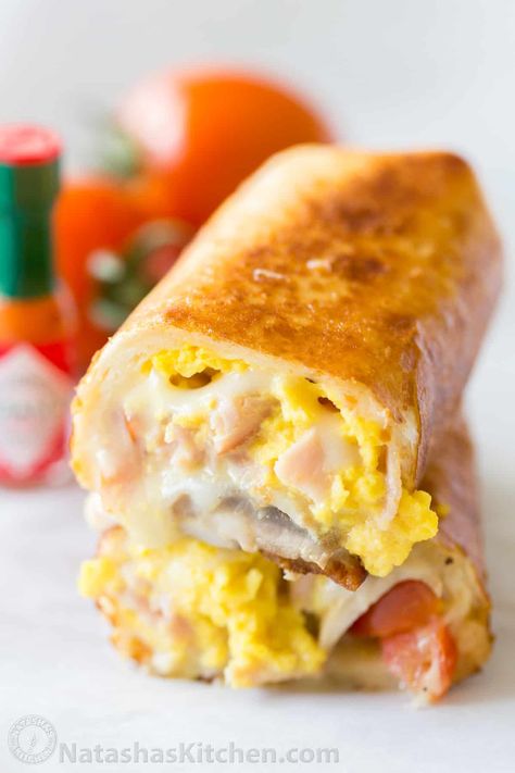 These Breakfast Burritos will make a breakfast person out of you. Crisp on the outside and filled with egg, ham and cheese. Easy freezer breakfast burritos! #breakfastburritos #breakfastburritorecipe #breakfastburrito #breakfast #natashaskitchen Burritos Freezer, Natasha Kitchen, Freezer Breakfast Burritos, Breakfast Burritos Frozen, Burrito Recipe, Breakfast Burritos Recipe, Frozen Breakfast, Breakfast Burrito, Burritos Recipe