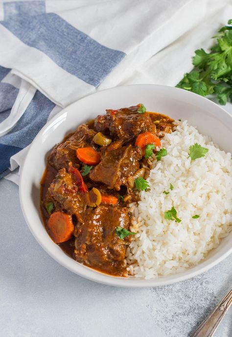 Traditional Dominican StyleSpicy Oxtail Stew (Rabo Encendio) made with beef oxtail, onions, peppers, garlic, cilantro, carrots, tomato sauce, latin seasonings. Dominican Oxtail, Spicy Beef Stew, Oxtail Stew Recipe, Beef Oxtail, Dominican Style, Oxtail Stew, Oxtail Recipes, Onion Relish, Spicy Dishes