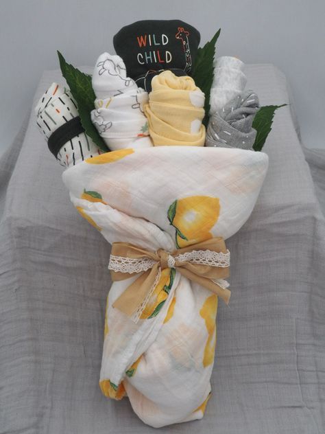 This unique baby shower gift bouquet will be sure to awe the ladies in your life. Amazingly cute alternative to diaper cakes and gift baskets. 8 onesies beautifully wrapped in a Muslim swaddle and completed with a ribbon bow. Onesies have a variety of patterns and designs and will have both long sleeve and short sleeve. Choice for bouquets are Girl, Boy or Neutral. Product received will not be the exact one as pictured; each bouquet is made fresh to order. We at Dreamy Diaper Creations guarantee Baby Boy Gifts Basket, Unique Baby Shower Gift Wrapping Ideas, Baby Shower Baskets Gift Ideas, Unwrapped Baby Shower Gifts, Wildflower Diaper Cake, Baby Boy Baby Shower Gift Ideas, Baby Shower Bouquet Ideas, Baby Shower Basket Gift Ideas Boy