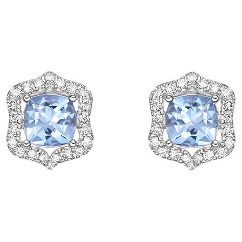 This collection features an array of aquamarines with an icy blue hue that is as cool as it gets! Accented with Diamonds. These Stud Earrings are made in white gold and present a classic yet elegant look. Aquamarine Stud Earrings in 18Karat White Gold with White Diamond. Aquamarine: 1.435 carat, 6X6mm size, cushion shape. White Diamond: 0.33 carat, 1.20mm size, round shape, G color, VS clarity Gold: 3.67g, 18Karat White Gold. Butterfly Pin and Push Back. E512 Aquamarine Studs, Diamond Tiara, Butterfly Pin, Icy Blue, Aqua Marine, Round Stud Earrings, Gold Butterfly, Blue Hues, Stud Earring