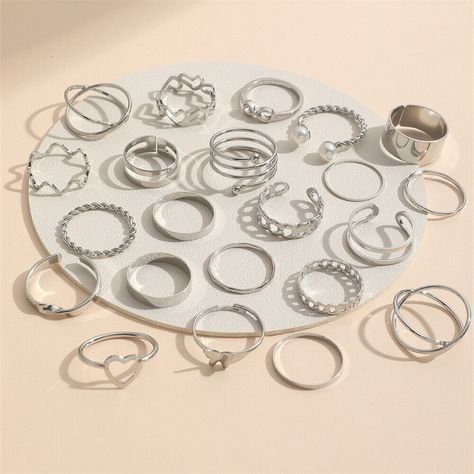 Features: 100% Brand New and high quality. Add a touch of elegance to your party attire with this 22pcs Silver Ring Set Multipack. the pack includes a variety of rings featuring heart, butterfly, wave, and twisted designs,all made of high-quality alloy material. The rings are sized to fit most and are perfect for adding a stylish touch to any outfit. The set is the ideal accessory for any occasion, including weddings, proms, and other special events.  The rings are available in a stunning silver color that complements any skin tone and outfit.  Simple but fashion design, chic decoration for you, make you more charm and elegant. Nice gift for your friends or lover. Type: Ring Set Material: Alloy,Imitation Pearl Size: about 1.5-1.8cm,Adjustable Color:Gold,Silver Package List: 1 Set of Rings Tvd Jewelry, Neck Pieces Jewelry, Pretty Jewelry Necklaces, Pearl Love, Silver Ring Set, Gold And Silver Rings, Finger Rings, Rings Set, Vintage Heart