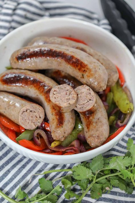 how to cook italian sausages on the stove in a white bowl with bell pepperss