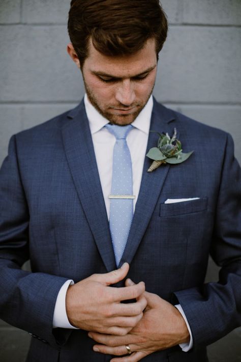 Handsome groom in dark navy suit getting ready before the ceremony. Navy blue suit looks good paired with light blue tie. #navysuit #groomattire #smokyhollowwedding Light Blue Tie With Navy Suit, Blue Suit Blue Tie Wedding, Navy Blue Suit Light Blue Tie, Tie With Navy Blue Suit, Navy Suit With Blue Tie, Dark Navy Blue Groomsmen Suits, Navy Blue Suit With Light Blue Tie, Dark Blue Suit With Light Blue Tie, Navy Suit Light Blue Tie