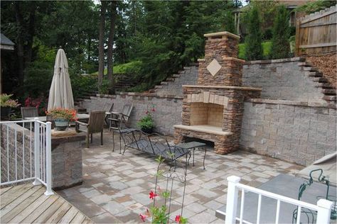 Stone fireplace built into retaining wall. Tall wall broken into ... Tall Retaining Wall Ideas Hillside, Tall Retaining Wall, Rancher Life, Terraced Patio Ideas, Retaining Wall Patio, Hillside Landscape, Easter House, Backyard Retaining Walls, Fireplace Outdoor