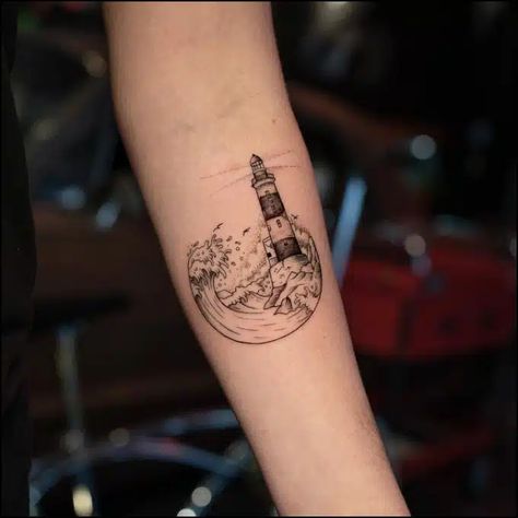 51+ Meaningful Lighthouse Tattoos: A Symbol of Guidance & Hope Lighthouse And Anchor Tattoo, Tato Idea, Lighthouse Tattoo Ideas, Lighthouse Tattoo Meaning, Traditional Lighthouse Tattoo, Lighthouse Tattoos, Ocean Sleeve Tattoos, Anniversary Tattoo, Storm Tattoo