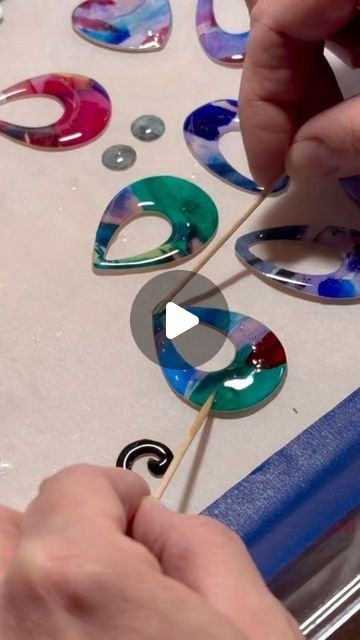 Becky Peach on Instagram: "I get asked how the resin stays on the watercolor cutouts. It’s mostly surface tension magic and fine detail with toothpicks. #watercolorjewelry #resin #resinprocess #behindthescenes" Watercolor Jewelry, Peach Watercolor, Epoxy Resin Jewelry, Surface Tension, Bead Sewing, Shower Tile Designs, Gold Line, Shower Tile, Resin Jewelry