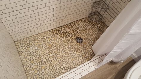 White subway tile with dark grout. Pebble floor, though maybe with dark stones? Pebble Shower Floor Dark Grout, Shower With White Subway Tile, Subway Tile With Dark Grout, Tudor Remodel, Brown Grout, Berlin House, Pebble Shower Floor, Dark Grout, White Tile Shower