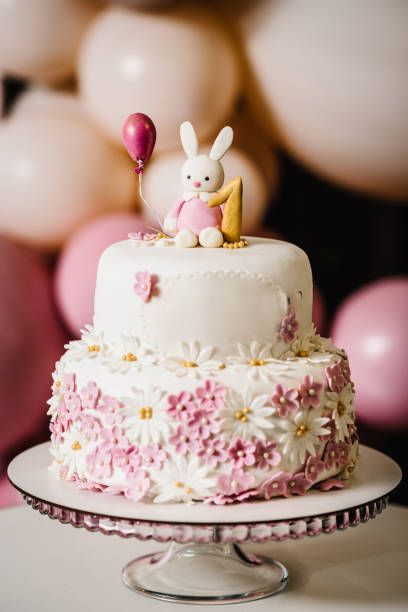 This easter bunny two-layer cake will be the perfect dessert for your Easter celebration. This cake was made for a very special party so I went all-in on the bunny theme and made matching bunny cookies and cakes too. #jsyummy #yummy #sweets #js #twolayer #whiteflowers #whitecake #topcake #bunnycake #whiteflavor #whitecream #best #easy #nice #amazing #stunning #unique #marvalous #special #trending #bunnytheme #bunnyimages #bunnyphotos #moistcake. Two Tier Bunny Birthday Cake, Bunny Theme Birthday Cake, Bunny Birthday Cake, 1st Bday Cake, Bunny Theme, Two Layer Cakes, Small Bunny, 5th Birthday Cake, Cake With Fondant