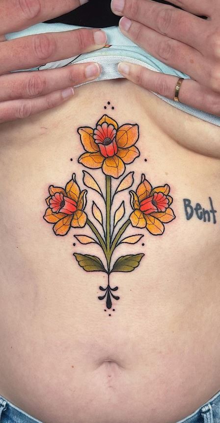 100 Meaningful Daffodil Tattoo Designs - Tattoo Me Now Linework Daffodil Tattoo, Vintage Daffodil Tattoo, Spring Flowers Tattoo, Traditional Style Daffodil Tattoo, Dafidol Flowers Tattoo, American Traditional Daffodil Tattoo, Spring Flash Tattoo, Daffodil Tattoo Traditional, Wildflower Back Tattoo