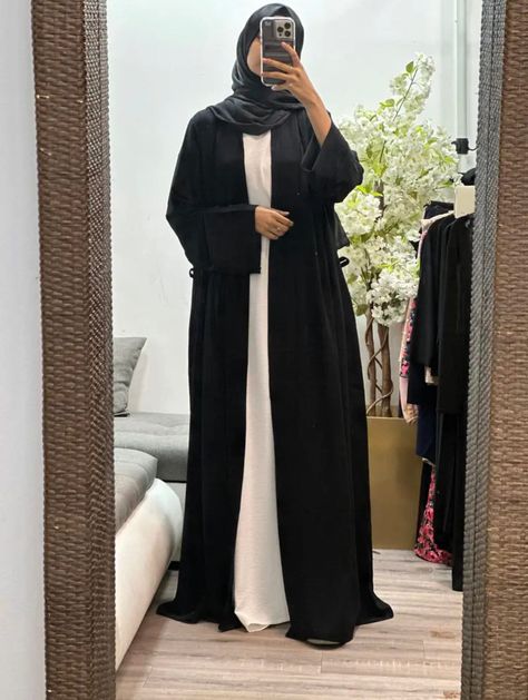 Elevate your modest wardrobe with our collection of open abayas. With a belt to cinch the waistline, this abaya is perfect for those who prefer a more fitted look. Available in four different colors, this versatile piece can be worn for any casual occasion. Season: All Seasons Stretch: None Occasion: Casual The long flare sleeves add a touch of elegance to the overall design and provide ample coverage. This open abaya is perfect for layering over your favorite outfits while still maintaining modesty. Incorporate this stylish piece into your everyday wardrobe and effortlessly enhance your Muslim fashion attire. Elevate your modest wardrobe with our collection of open abayas. With a belt to cinch the waistline, this abaya is perfect for those who prefer a more fitted look. Available in four Open Abayas, Elegant Abayas, White Abaya, Abaya Outfit, Modest Wardrobe, Open Abaya, Black Layers, Flare Sleeves, Muslim Fashion Outfits