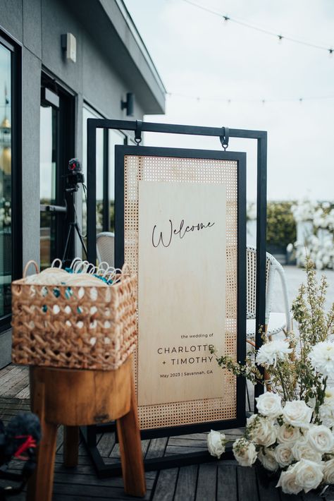 Black and rattan wood wedding welcome sign for a rooftop celebration in Savannah, Georgia. Planning by Plume Events and photo by 7Nine Photography. Rattan Wedding Invitation, Rattan Signage, Rattan Seating Chart, Unique Wedding Welcome Sign Ideas, Wood Wedding Signage, Wedding Add Ons, Rattan Wedding Decor, Unique Welcome Signs Wedding, Diy Wood Wedding Signs