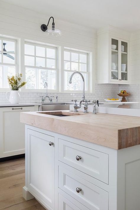 A butcher block prep island sits at the end of a larger kitchen island and is fitted with satin nickel hardware and a prep sink with a polished nickel deck mount faucet. Cottage Style Kitchen, Prep Sink, Large Kitchen Island, Top Decor, Ideas Hogar, White Kitchen Cabinets, Farmhouse Sink, Trendy Kitchen, Cottage Kitchen