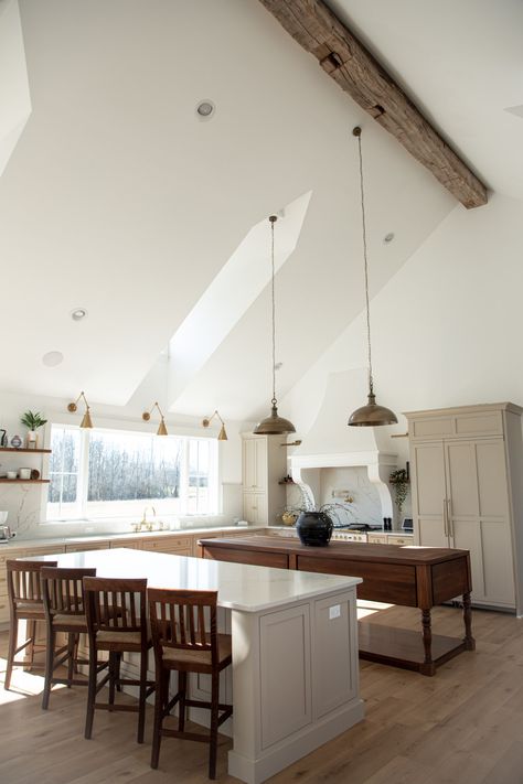 Kitchen with natural light streaming through the dormers, and 10 foot kitchen window.  Tall, vaulted, cathedral ceilings with 150 year old barn beam.  Large brass pendants hanging.  Double kitchen islands, one quartz and the other a walnut wood bakers table. 4 Chair Kitchen Island, Two Islands Kitchen, Large Island With Table Attached, Kitchen With 2 Entrances, Large White Island Kitchen, Double Counter Kitchen Island, Off Center Kitchen Island, Two Islands In Kitchen, Two Kitchen Islands Layout