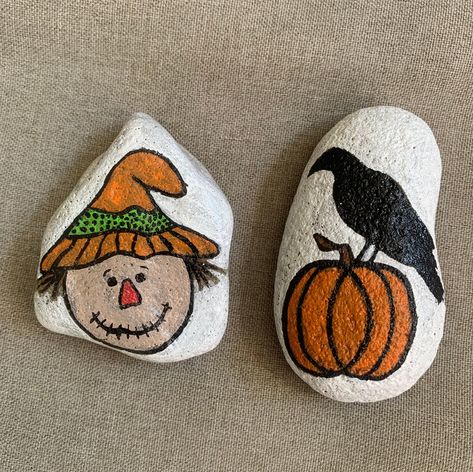 This is a set of 2 hand painted rocks. one is a scarecrow's face and the other is a raven sitting atop a pumpkin. painted with acrylic paint and sealed with a heavy duty clear coat to help protect against dirt, scratches and weather. Measurements are as follows: Scarecrow: 2.125" x 3.625" x 1" Raven with pumpkin: 3.125" x 1.75" x 1" If you have any questions please ask! Pumpkin Painted, Season Decorations, Scarecrow Face, Painting Stones, Halloween Rocks, Rock Painting Ideas Easy, Rock Painting Patterns, Rock Ideas, Seashell Art