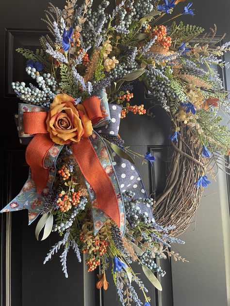 oval grapevine fall wreath with blue and orange flowers and polka dot ribbons for front door Oval Grapevine Wreath, Orange And Blue Flowers, Fall Grapevine Wreath, Indoor Home Decor, Fall Grapevine Wreaths, Corporate Flowers, Roses Blue, Silk Florals, Upcycle Decor