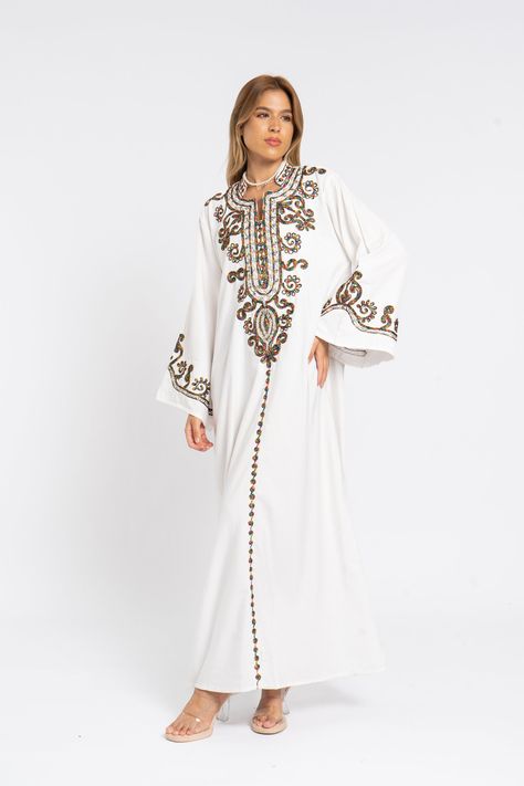 *Note : The kaftan in the video is a different color and is only displayed to show the fit, flow, and cut of the Kaftan. You will receive the one in the pictures.* This stunning kaftan with its monotone embroidery will be your summer favorite. It is an extremely comfortable wear, light and soft and can be used on many occasions -  home gatherings, festival parties, summer occasions, dinners, or just in your home to feel comfortable.  Fabric : 70% Egyptian Cotton and 30% Polyester Sizes : The dress comes in two sizes. S/M/L which fits up to a size 14 US (Large) and one that fits up to a size 22 US (2XL). It comes with a cinch in the back to accentuate your beautiful body.   Kaftan measurements in inches : S/M/L Bust : 44-45 Hip : 50-51  X/2XL Bust : 49-50 Hip : 55-56 Length : 57 inches For Embroidered Caftan, Cotton Caftan, Belle Silhouette, White Flares, Summer Favorites, Caftan Dress, Egyptian Cotton, Look Plus, Festival Party