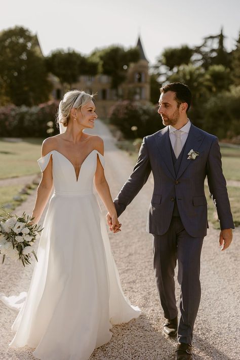 Bride wears pearl bridal headband and carries white rose bouquet as she holds her grooms hand who wears three piece blue suit Beige Wedding Suit, Forest Wedding Ceremony, Suit Groom, Suzanne Neville, Provence Wedding, White Bridesmaid, Beige Wedding, White Bridesmaid Dresses, Rock My Wedding