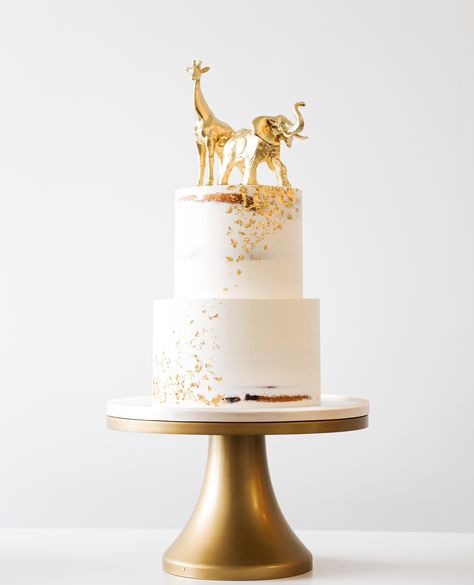 When simple just won't do! Let us add a touch of gold! #earthandsugar #thesweetlife #bakeitbetter #bakeyourworldhappy #cakestagram #cakedesign #wedding #cakesofinstagram #cakes #cake #buttercream #cakelover #cakedecorating #instacake #cakeart #miami #cakedecorator #palmbeachcakery #thebakefeed #cakesdaily #seminaked #seminakedcake #buttercreamcake #gold #goldpainted #giraffe #elephant Giraffe Print Cake, Safari Wedding Cake, Simple Safari Cake, Rustic Birthday Cake, Giraffe Baby Shower Theme, Giraffe Birthday Cakes, Gold Safari Baby Shower, Jungle Safari Cake, Safari Baby Shower Cake