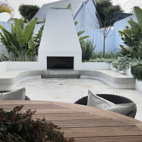 Loving this small backyard garden with custom built in seating that embraces the stunning outdoor fireplace 😍 The key to small space design is leading the eye to a focal point to deter the sense of limited space. Minimising furniture by designing creative solutions for seating areas is another great space saver and where possible adding green on the ground such as a small patch of lawn always gives the illusion of more space 💚 Soul Project @jennifer_newell_design Landscape Design @outside... Small Sunken Seating Area Garden, Built In Garden Seating, Small Backyard Garden, New Home Build, Outside Fireplace, Sunken Garden, Pink Lake, Built In Bbq, Small Backyard Gardens