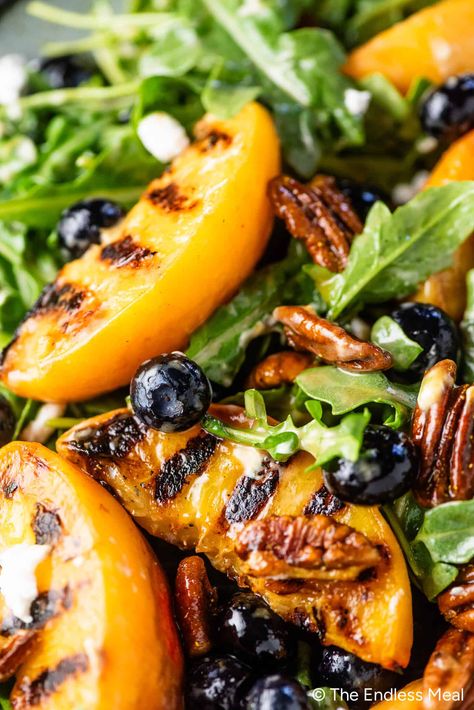 This grilled peach salad is incredible! The sweet and smoky grilled peaches meld with peppery arugula, blueberries, candied curry pecans, goat cheese, and a honey vinaigrette. #theendlessmeal #peaches Salad Coleslaw, Shake Recipes Healthy, Summer Side Dishes Recipes, Best Salads Ever, Honey Vinaigrette, Grilled Peach Salad, Grilled Salad, Summer Side Dish, Peach Salad