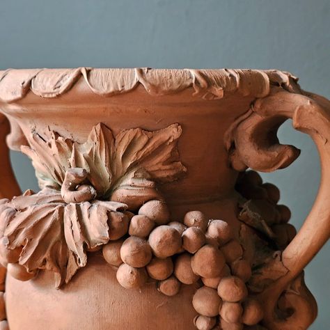 Hand crafted ceramic urn in terracotta tone. Grape Cluster and leaf motif with floral petal accents on rim and base. Ceramic Urn, Ceramic Inspiration, Aesthetic Space, Ceramics Ideas, Topiaries, Leaf Motif, Thrown Pottery, Ceramics Ideas Pottery, Pottery Ideas