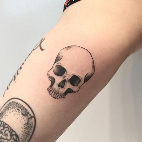 Skull tattoos are an extremely popular form of symbolism seen in both culture and tattoos. Let's explore the most common skull tattoos and their meanings. Skull Tattoos Small Simple, Micro Skull Tattoo, Skull Tattoo Patchwork, Simple Skull Tattoos For Women, Simple Realism Tattoo, Small Skull Tattoo For Women, Skull Tattoos Simple, Minimal Skull Tattoo, Minimalist Skull Tattoo