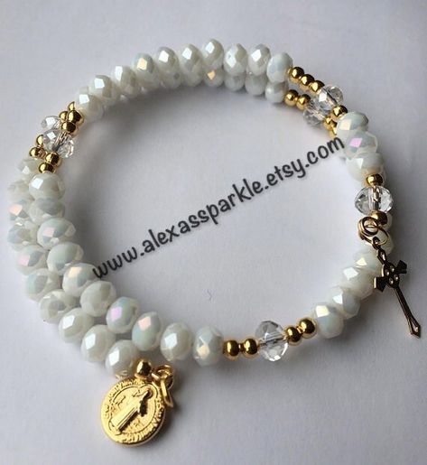 The bracelets are made with gold colored memory wire. The beads are crystal rondelle size 6mm of a white color. The bracelet is made as a Rosary bracelet and each of it's sections is separated by a crystal rondelle bead. The charms are gold plated. The bracelets will fit most wrists as they expand. The bracelets are sold by the dozen and make great favors or gifts for religious celebrations such as baptisms, confirmations, first communions, etc. If you have any questions or would like a custom o Memory Bracelets, White Rosary, Memorial Bracelet, Rose Bracelet, Rosary Bracelet, Protection Bracelet, Memory Wire, Evil Eye Bracelet, Red And Gold