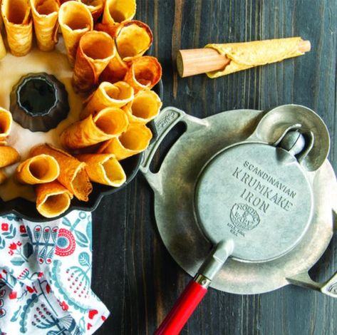 Makes traditional Scandinavian cone-shaped cookies, Imprints a pattern of flowers and leaves on each cookie, Iron is made of cast aluminum base and has a large well to capture excess butter and reduce flare-ups. It can be used on gas, electric and ceramic stoves. Wood rolling cone and recipes included. Proudly made in the USA by Nordic Ware.