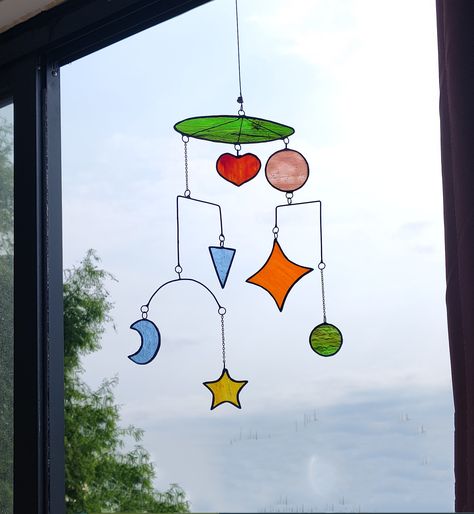 This beautiful mobile suncatcher features a vibrant Geometric patterns design made of stained glass Hang it in your home and let the sunlight shine through the colorful glass, creating a stunning visual display in your home Top fixing connector to adjust lead length We offer 2 lengths of cord. (150cm - 4.9ft   and  200cm - 6.5ft) Choose the length you want according to the height of the house Stained Glass Mobile, Glass Mobile, L'art Du Vitrail, Mobile Hanging, Mobile Art, Geometric Pattern Design, Stained Glass Diy, Hanging Mobile, Stained Glass Designs