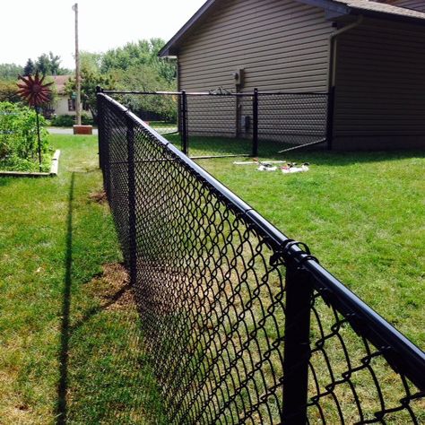 I am SO glad this project is DONE! We learned a lot and saved a TON of money doing it ourselves, about $2,000.  There was some arguing, sweat and blood involved.  In the end it was all worth it and… Fencing Ideas For Dogs, Painted Chain Link Fence, Backyard Fencing Ideas, Black Chain Link Fence, Backyard Fencing, Diy Dog Fence, Chain Fence, Fence Fabric, Ideas For Dogs