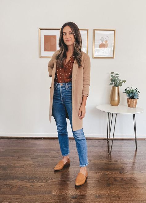 ashley wearing a patterned rust colored peasant blouse, medium wash jeans, and cognac loafers; in the background a white side table with 2 faux plants and 3 prints in gold frames Joanna Gaines Outfits Fall, Office Outfits Fall 2023, Plus Size Casual Professional Outfit, Madewell Winter Outfits, Fall Photoshoot Women Outfit, Fall Womens Work Outfits, Easy Fall Outfits For Work, Fall Style For Women In Their 30s, Working Mom Outfits Business Casual