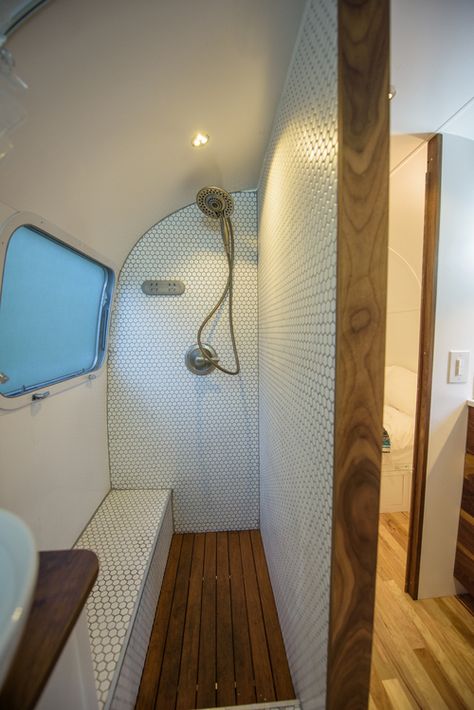 Gorgeous bathroom shower design and built by Townsend Travel Trailers. Teak floors and hexagon tile make for a great combination in this renovated vintage airstream trailer. Airstream Bathroom, Bus Conversions, Airstream Remodel, Airstream Interior, Bus Living, Airstream Renovation, Teak Flooring, Caravan Renovation, Kombi Home