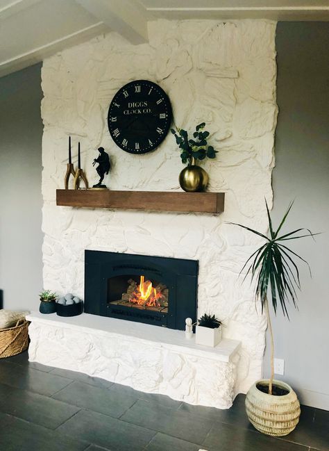 White Brick Wood Mantle, 70s Fireplace Makeover Stone, Lava Stone Fireplace, Fireplace Painting Ideas Stone, Painted Lava Rock Fireplace, Stone Fireplace Makeover Modern, Stone Fireplace Painted White, Painted Fireplace Rock, Old Rock Fireplace Makeover