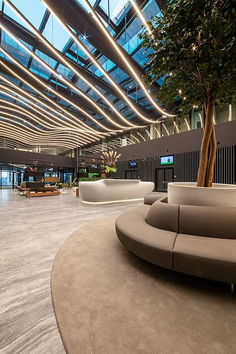 Gallery of Coverlam Medusa in Hillside Office Building - 3 Office Building Reception Lobby, Modern Atrium Design, Entertainment Building Design, Atrium Lighting, Building Lobby Design, Building Entrance Lobby, Lobby Ceiling Design, Building Entrance Design, Mall Architecture