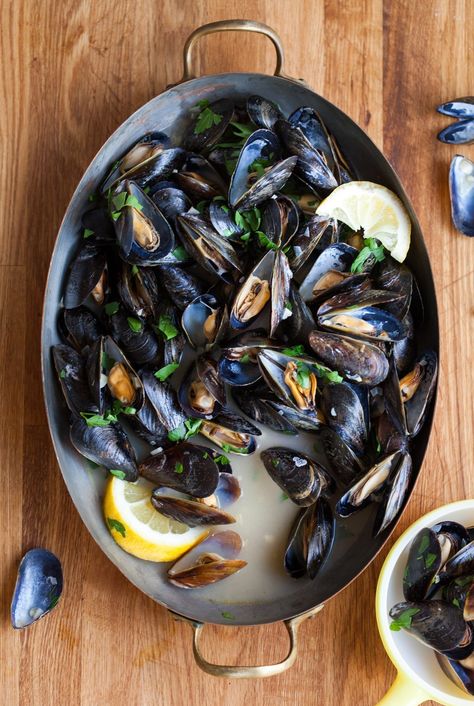 Whether we're talking about a dinner party or a quick weeknight meal, it doesn't get much better than a giant bowl of steamed mussels. This dish has the kind of easy elegance and immediate gratification that I look for in both cases.   	Today, I'm sharing my favorite, most basic method for quickly steaming a batch of mussels. It's simple — just mussels steamed with broth and white wine — but oh so very good! Steamed Mussels, Mussels Recipe, Romantic Meals, Romantic Dinner Recipes, Cooking Lessons, Fish Dishes, Seafood Dishes, How To Cook, Fish Recipes