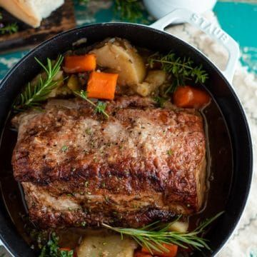 Tender and juicy, this Dutch Oven Pork Roast transforms an affordable cut of meat into a delicious comfort food dinner. The pork loin slowly bakes in an apple cider broth with potatoes, carrots, celery, onion and herbs. A quick pan gravy adds the perfect finishing touch on the one pot meal. Serve this simple boneless pork roast recipe with a side of flaky buttermilk biscuits or a pan of cornbread for your next cozy Sunday supper! Dutch Oven Pork Roast, Oven Pork Roast, Roast In Dutch Oven, Dutch Oven Pork, Pork Roast With Gravy, Boneless Pork Loin Recipes, Pork Pot Roast, Roast With Gravy, Pork Sirloin Roast