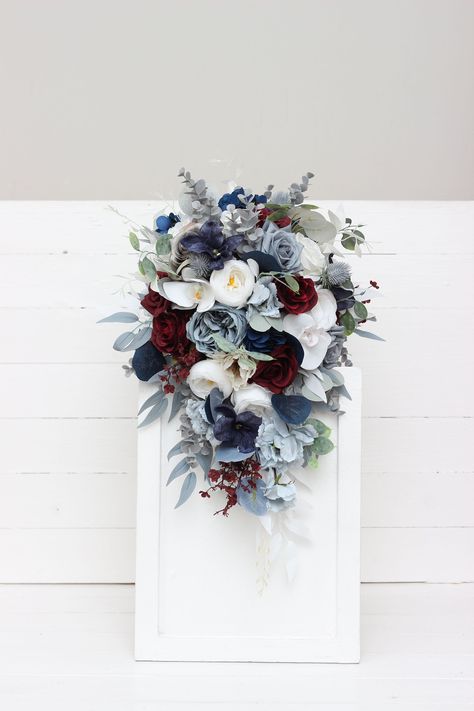 "The bouquet is made of flowers and leaves of high quality. All dimensions are total length or width. The length of the cascading bouquet is 20\" Thanks for visiting 😊" Navy Blue And Grey Wedding Centerpieces, Blue And Gray Bouquet, Dusty Blue And Burgundy Bouquet, Navy Dusty Blue And Burgundy Wedding, Maroon Navy Gold Wedding, Dusty Blue Burgundy And Sage Wedding, Red And Blue Bridal Bouquet, Dusty Blue And Burgundy Wedding Cake, Fall Wedding Flowers October Blue