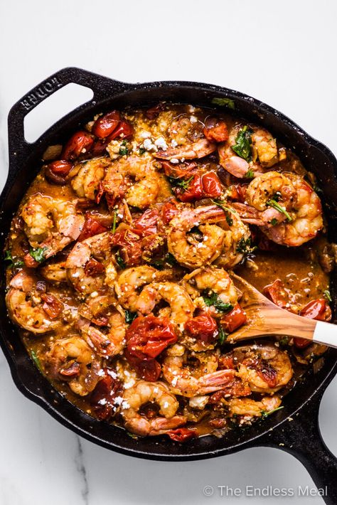 Greek shrimp is an easy and healthy recipe made with tender shrimp cooked in a garlicky cherry tomato sauce with feta cheese. This Mediterranean meal is ready in under 30 minutes making it the perfect weeknight dinner! #theendlessmeal #greekshrimp #mediterraneanshrimp #shrimp #greek #mediterranean #mediterraneanrecipe #seafood #prawns #greekprawns #greekfood #greekrecipe #tomatosauce #quickdinner #weeknighdinner #healthydinner Shrimp With Tomatoes, Greek Shrimp, Greek Lemon Potatoes, Tomatoes And Feta, 30 Minute Meals Healthy, Southwest Salad, Cherry Tomato Sauce, Greek Seasoning, Shrimp Recipes For Dinner