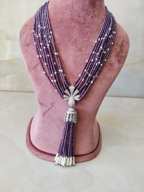 A beautiful treat for your eyes and your wardrobe. We this beautiful long pearl tassel necklace on your special occasion. Single stranded baroque pearl in tear tear drop shape and  tassel necklace with original  onyx beads binded long tassel. Purple Beaded Jewelry, Seed Bead Jewelry Patterns, Bridal Necklace Designs, Gold Temple Jewellery, Indian Jewelry Earrings, Stones Necklace, Silver Necklace Set, Purple Beaded, Beads Jewellery