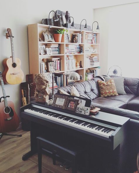 Small apartment living room with enough space for a small piano, guitars, book shelves and leather sofa! Seattle area, issaquah,WA Small Piano Room Layout, Piano In A Small Living Room, Piano Apartment Small Spaces, Piano In Living Room Small Spaces, Keyboard Piano In Living Room, Piano Small Living Room, Keyboard In Living Room, Piano Area In Living Room, Shelf For Piano Books