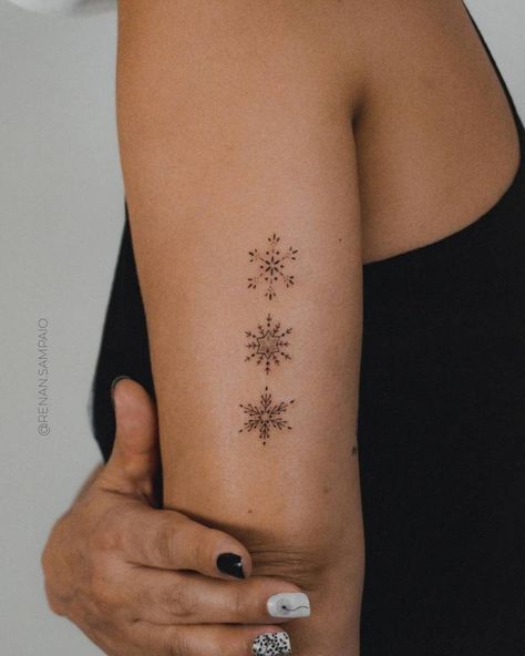 Fine line snowflakes tattoo on the tricep. Snowflake Fine Line Tattoo, Snowflake Shoulder Tattoo, Winter Tattoo Ideas Nature, Dainty Snowflake Tattoo, Subtle Christmas Tattoo, Ornamental Snowflake Tattoo, Sun And Snowflake Tattoo, Fine Line Snowflake Tattoo, Snow Tattoo Snowflakes