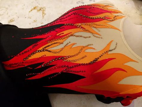 A close up view of the flames dress on a dress form, with red and orange crystals applied to it. Flame Inspired Dress, Jazz Dance Costumes Sassy Red, Flame Clothes, Fire Element Outfit, Fire Inspired Dress, Flame Costume, Jazz Dance Costumes Sassy, Fall Fairy Costume, Cruella Movie