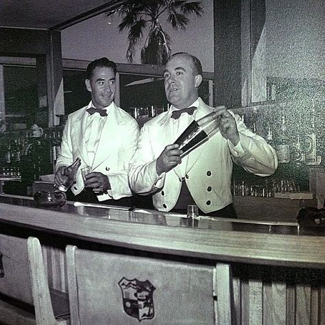 Early 1950's, two bartenders showing off their skills at the Shadow Mountain Clubhouse. Check out the Shadow Mountain Crest on the back of the chairs. Vintage Bar Outfit, 1940s Bartender, 1950s Speakeasy, 1920s Bartender, 1950s Bar, Bartender Uniform, Don Perignon, Bartender Outfit, Pizza Art