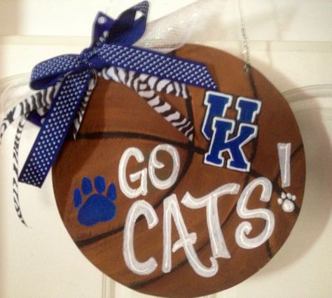 I created this team door hanger using plywood, then painted it with the wildcats theme :-) Uk Door Hanger Kentucky Wildcats, Uk Door, Diy Basketball, Football Door Hangers, Jigsaw Projects, Plywood Projects, Galaxy Gifts, Cat Decor Diy, Burlap Door Hanger