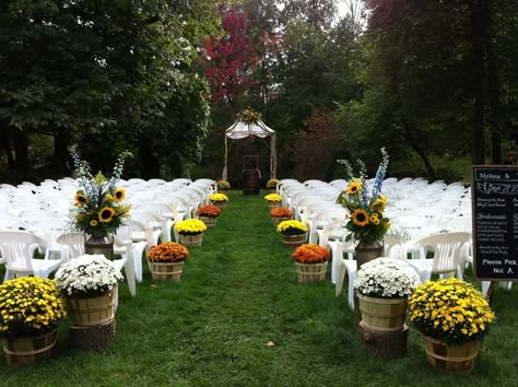 Our aisle decoration. We used 14 potted mums in bushel  baskets, 2 beautiful flower arrangements from Vandersaalm-Flipse flowers and our handmade birch wood arch to decorate. #rusticwedding #fallwedding Fall Wedding Mums, Potted Mums, Wedding Aisle Outdoor, Mums Wedding, Fall Wedding Ceremony, Bushel Baskets, Wedding Isles, Fall Mums, Aisle Flowers