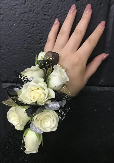 elongated wristlet with 7 White Spray Roses, silver, black and gold ribbons. White And Black Corsage, White Rose Corsage, Black Corsage, White Spray Roses, Wedding Corsages, Rose Corsage, Prom 2024, Corsage Wedding, Wrist Corsage