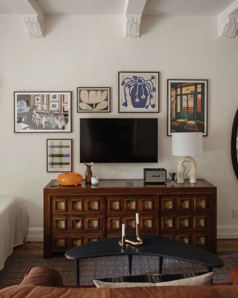 Art prints surround media console in newly remodeled apartment. Decor Around Tv, Studio Apartment Living, Interior Design Gallery, Apartment Makeover, Gallery Wall Living Room, Michael Scott, Apartment Style, Bedroom Vintage, Apartment Interior Design